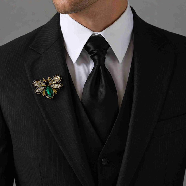 Man wearing a crystal bee brooch on a black suit lapel 