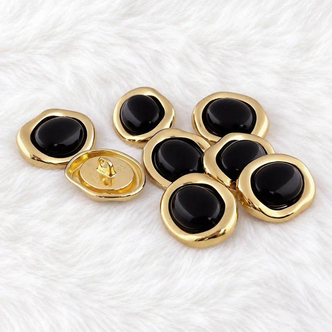 ANI Accessories black enamel and gold buttons on white fur with white color fur background 
