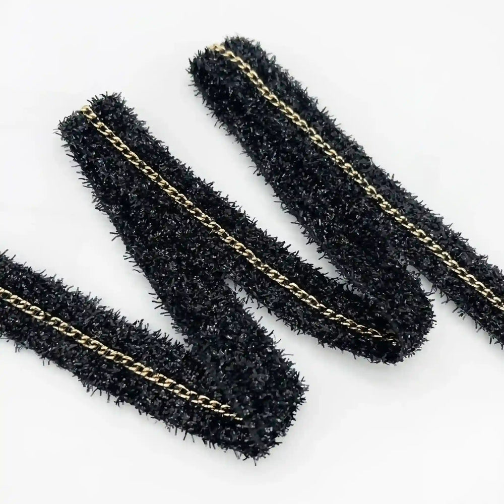 ANI Accessories black glitter lace border folded in a zigzag with white color background 