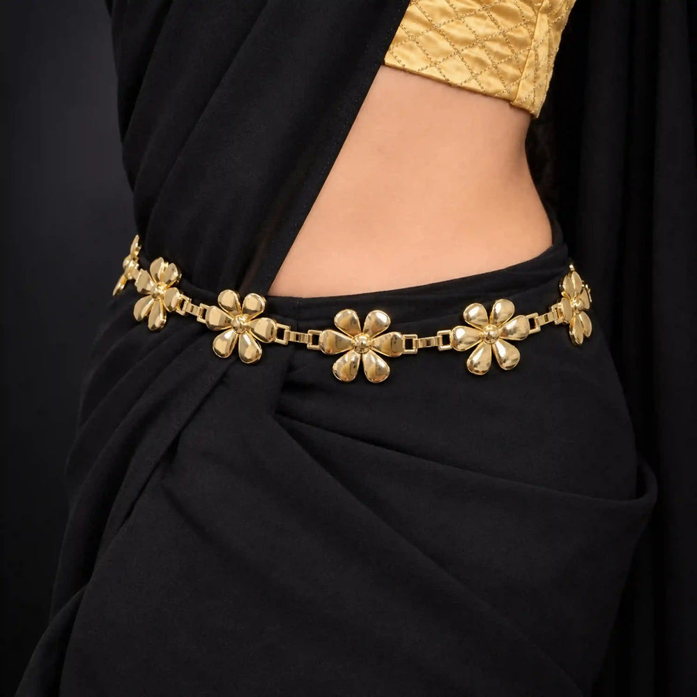 ANI Accessories bright gold daisy flower chain belt worn on a black saree 
