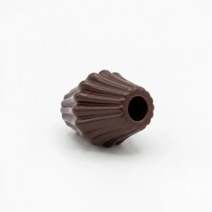 ANI Accessories dark brown melon cord end bead lying on its side, angled view of fluted ridges and hole opening on white Background 