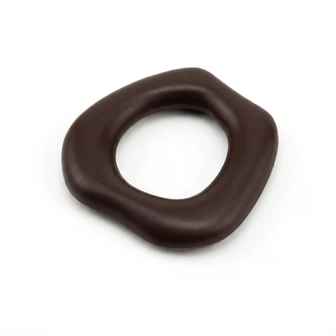 ANI Accessories dark brown organic ring pendant charm lying flat, angled view of the smooth rounded edges and open centre