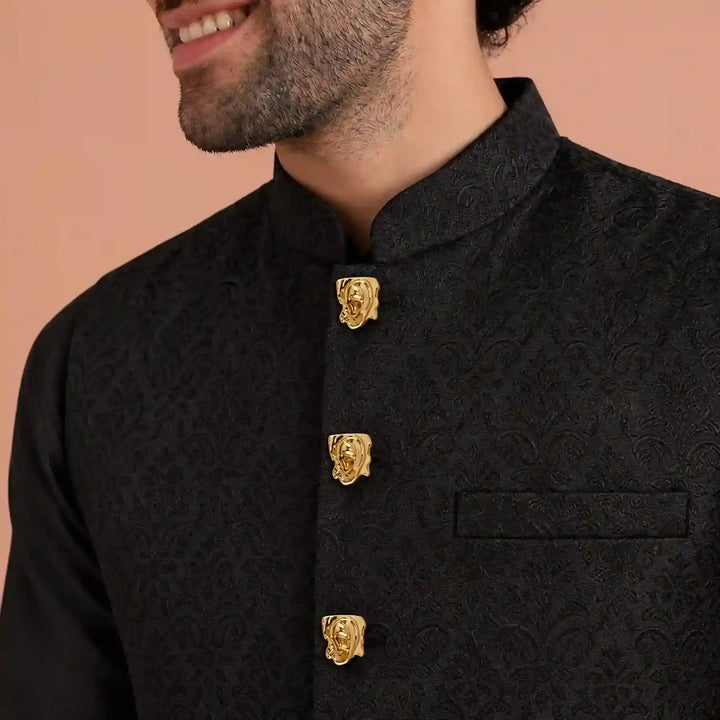 ANI Accessories designer bandhgala buttons in gold ear design on a black bandhgala with white color background 