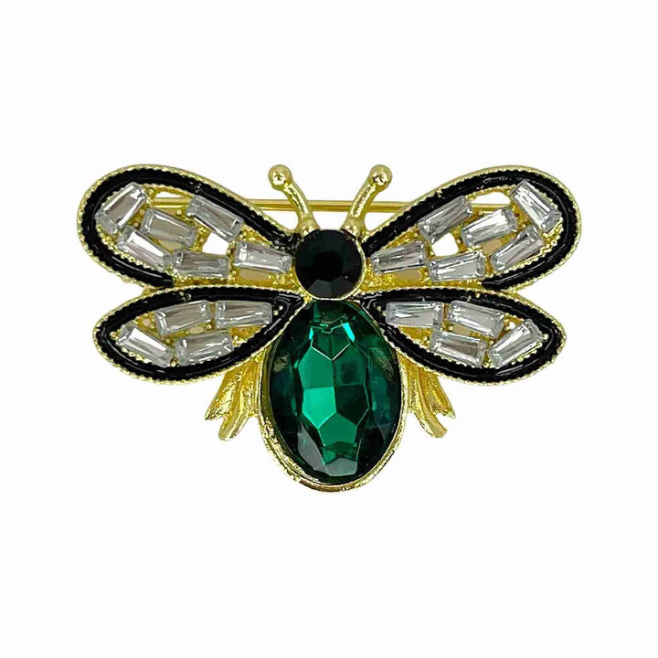 Crystal bee brooch with baguette crystal wings and green emerald-colour body with white color background 