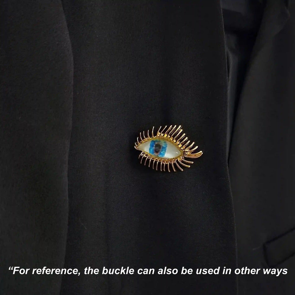 ANI Accessories radiant eye pin brooch pinned on the chest of a black shirt with white color background 