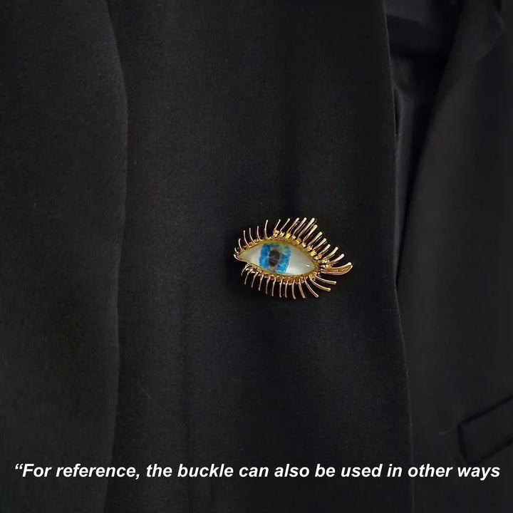 ANI Accessories radiant eye pin brooch pinned on the chest of a black shirt with white color background 