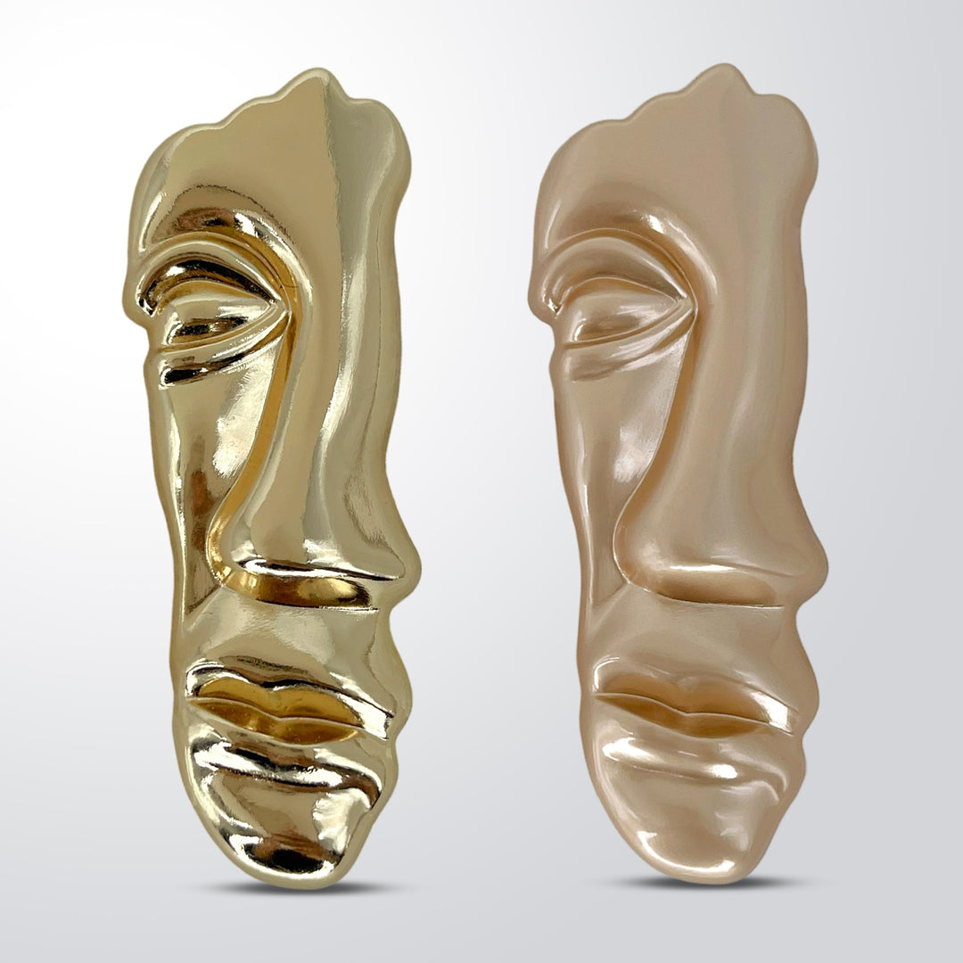 ANI Accessories face inspire metal brooch in shiny gold and matte gold, side by side 