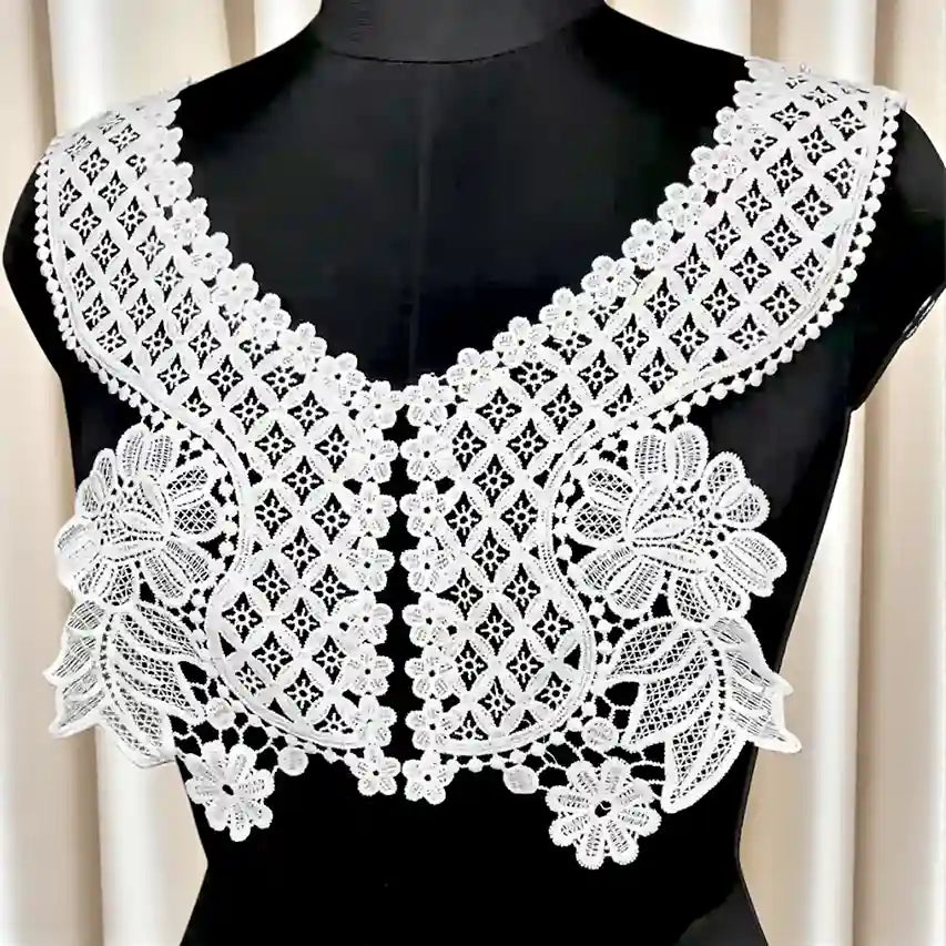 Floral V neck patch on a black mannequin against a white background 