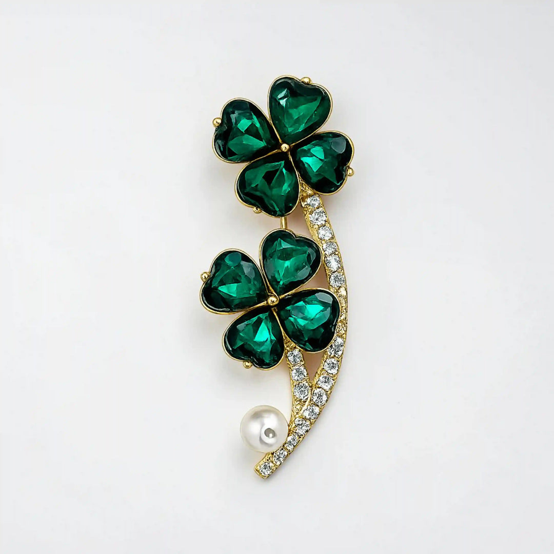 ANI Accessories four leaf clover brooch with emerald green crystals and white pearl, front view on white 