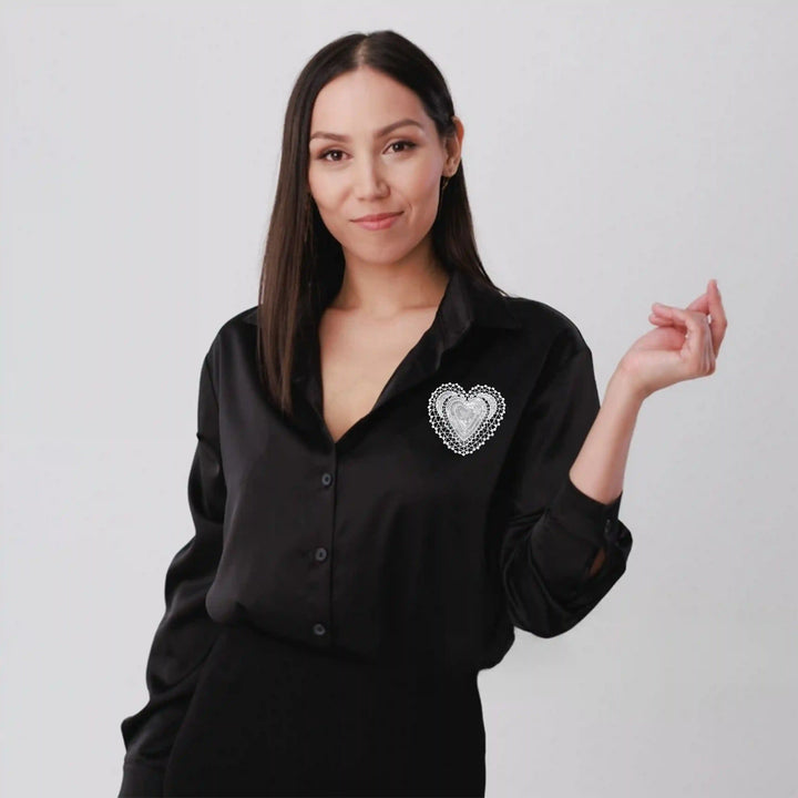 ANI Accessories white glitter heart patch stitched on the chest of a black shirt 
