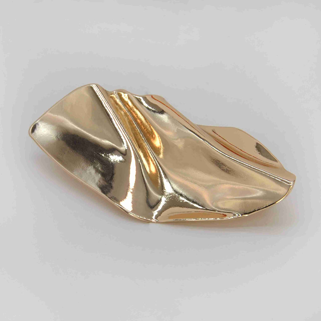 ANI Accessories gold buckle for dress with molten leaf design, top view on grey 
