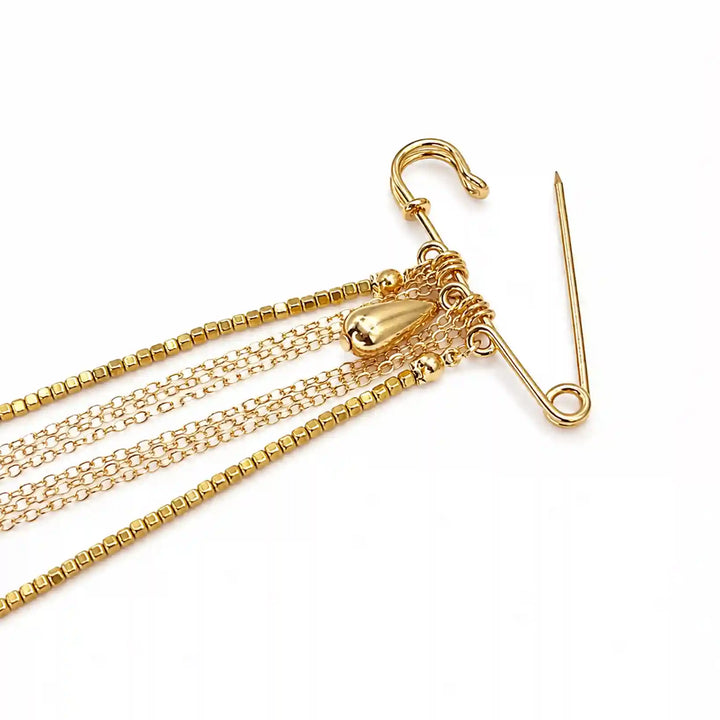 ANI Accessories gold chain tassel brooch close-up showing the safety pin clasp and chain links with white color background 