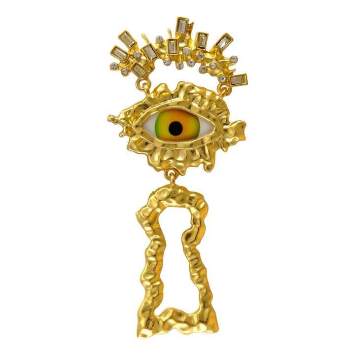 Gold eye and keyhole brooch with green iris on white background 
