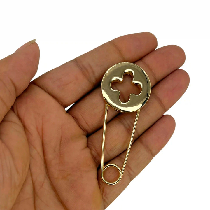ANI Accessories gold kilt pin held in hand to show its size