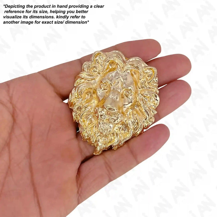 Gold lion metal brooch held in hand to show its size with white color background 