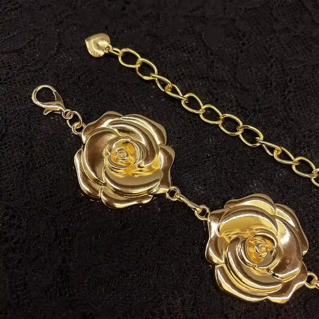 ANI Accessories close-up of gold metal roses and lobster clasp on a chain belt with white color background 
