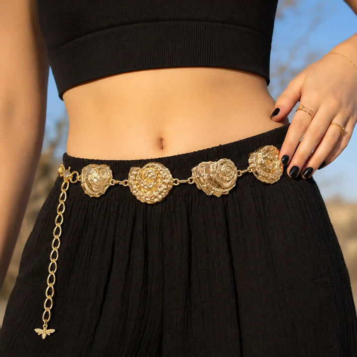 ANI Accessories gold shell waist chain belt worn with a black skirt and crop top 