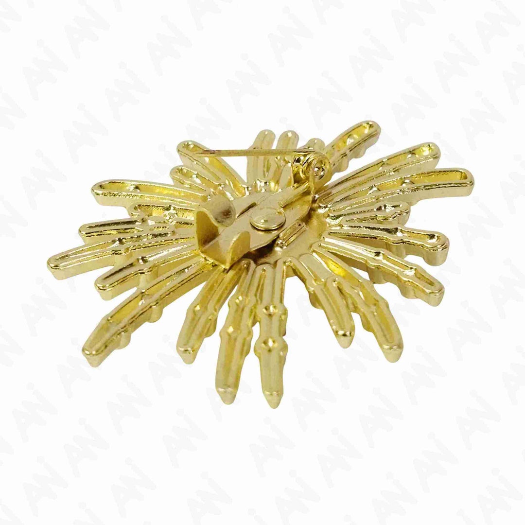 ANI Accessories gold sunburst brooch from an angle showing the textured rays and pearl