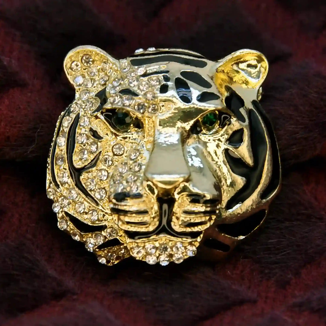 Gold tiger head brooch with green stone eyes and rhinestones on maroon fur 