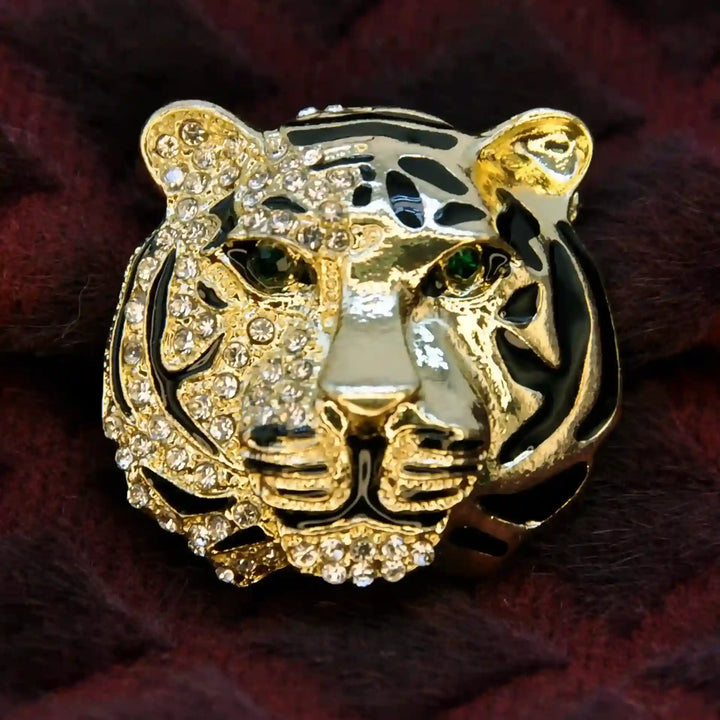 Gold tiger head brooch with green stone eyes and rhinestones on maroon fur 