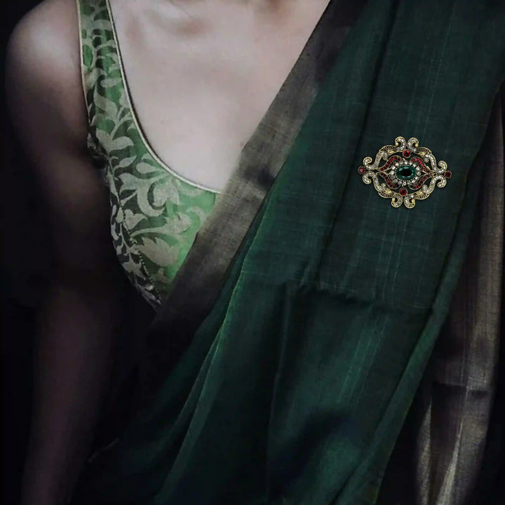 ANI Accessories green saree brooch pinned on the pallu of a dark green saree 