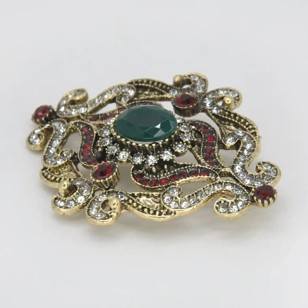 ANI Accessories green stone brooch from an angle showing the raised emerald-green centre