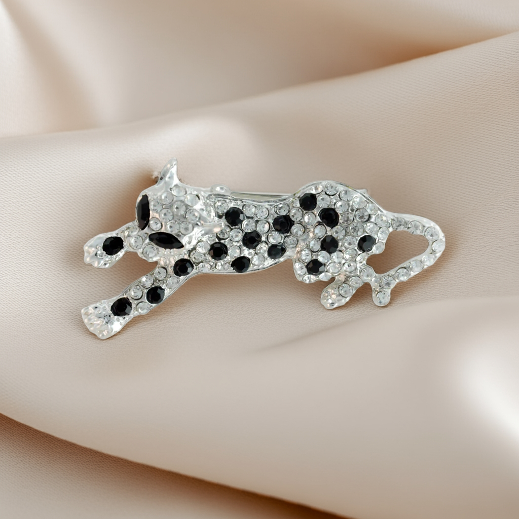 ANI Accessories jeweled leopard brooch pin in silver with clear rhinestones and black spots on beige satin 