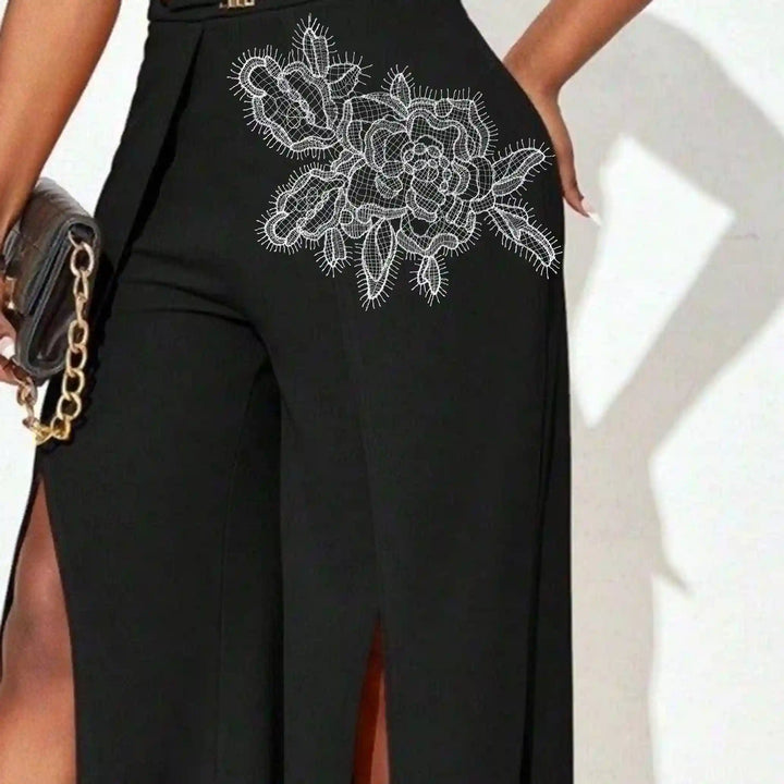 ANI Accessories large white flower patch stitched at the hip of black trousers 