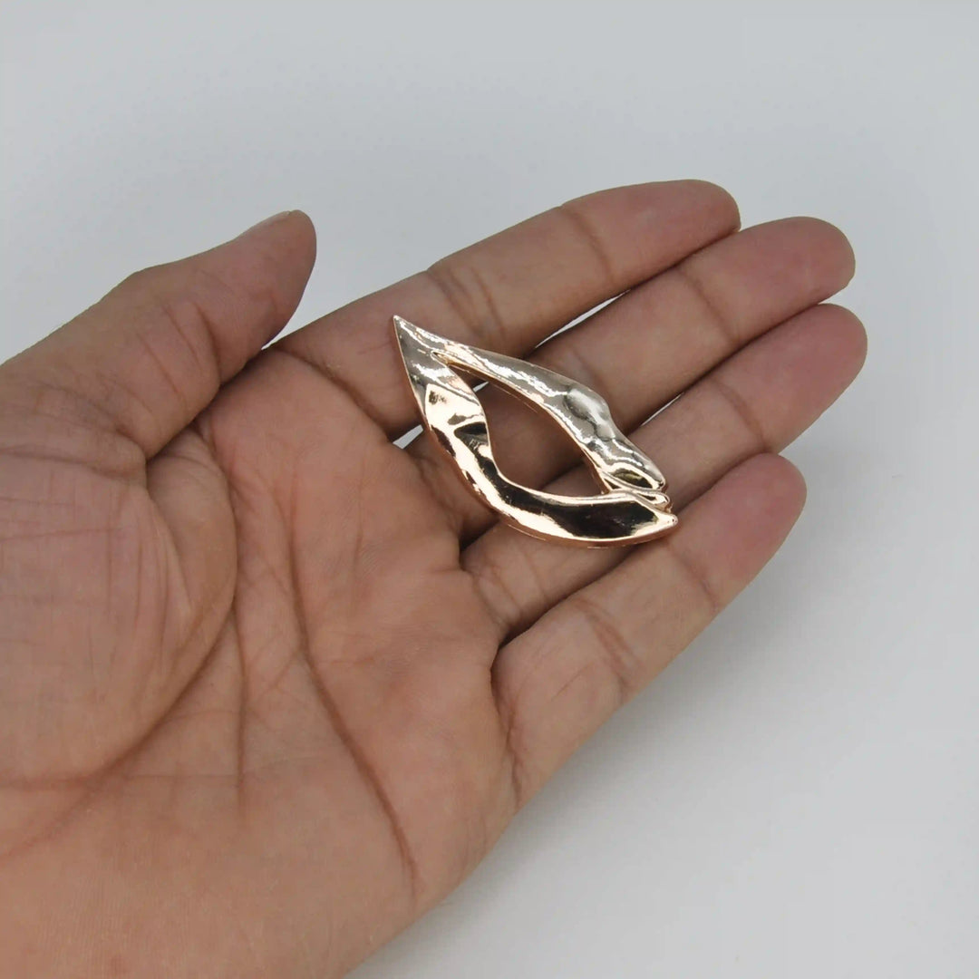 ANI Accessories lip shaped brooch held in hand to show its small size 