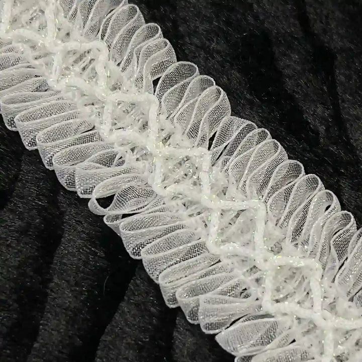ANI Accessories close-up of loop fringe trim with diamond cord centre with black color background 