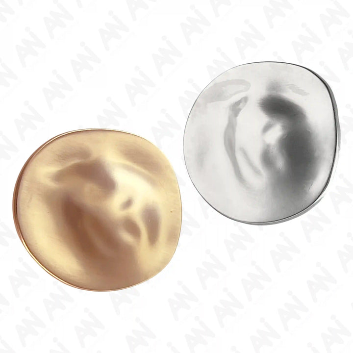 ANI Accessories lunar glow metal brooch in gold and silver with a rippled moon-like surface color background 