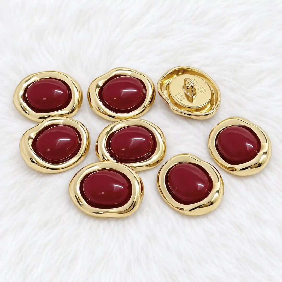 ANI Accessories maroon enamel gold buttons on white fur with white color fur background 