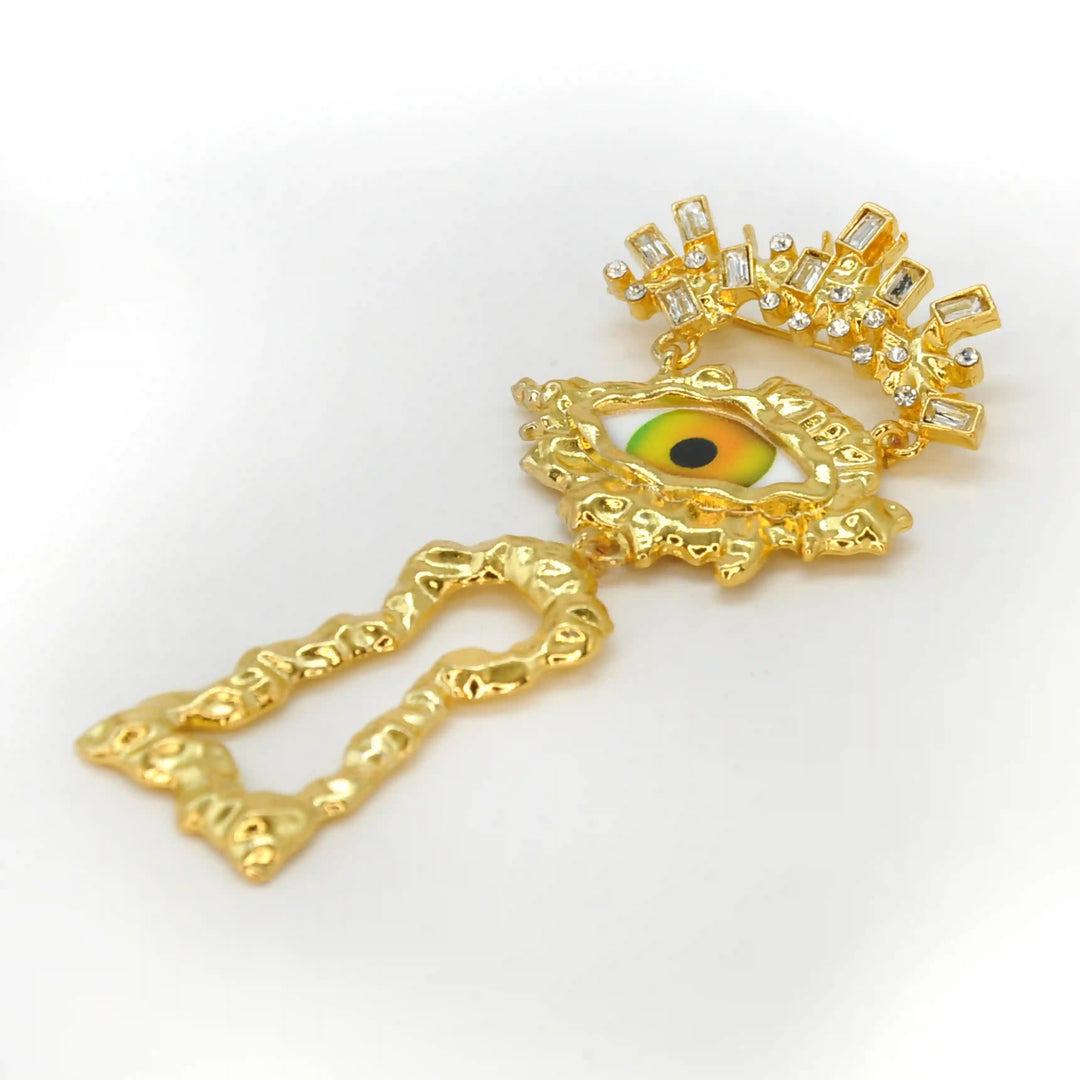 Side view of the mystic eye brooch pin showing the textured gold keyhole 