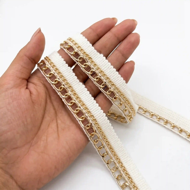 ANI Accessories off white chain lace held in hand to show the fine and bold gold chains with white color background 