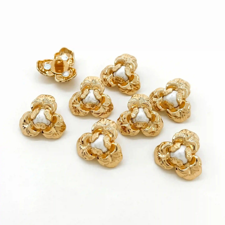 ANI Accessories set of 8 gold three-petal flower metal shank buttons with pearl-look centres scattered on white Background