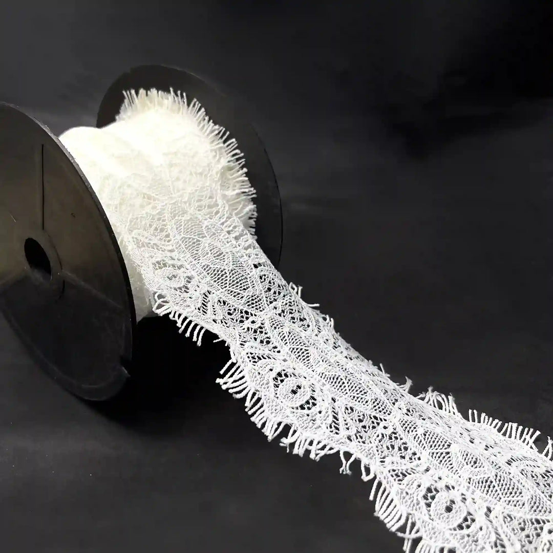 A roll of Scalloped Edge Eyelash Lace in white, perfect for crafting and decoration projects.