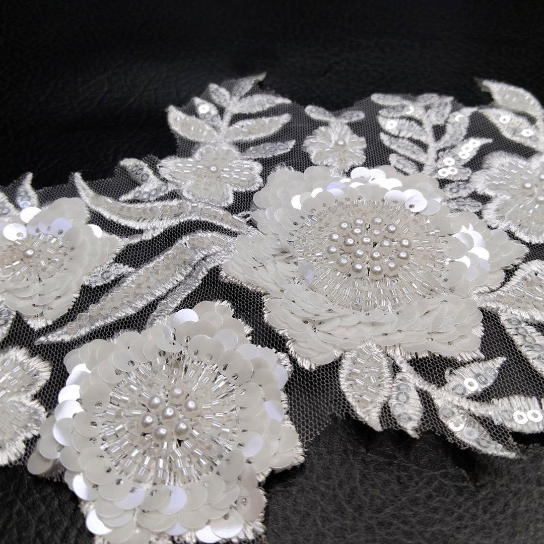 ANI Accessories close-up of clear sequins and beaded flower centres on a white embroidery patch 