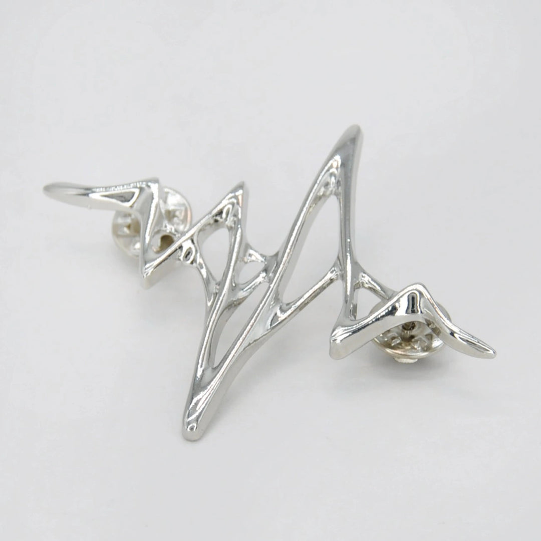 ANI Accessories silver wave lapel pin from an angle showing the raised wire design 