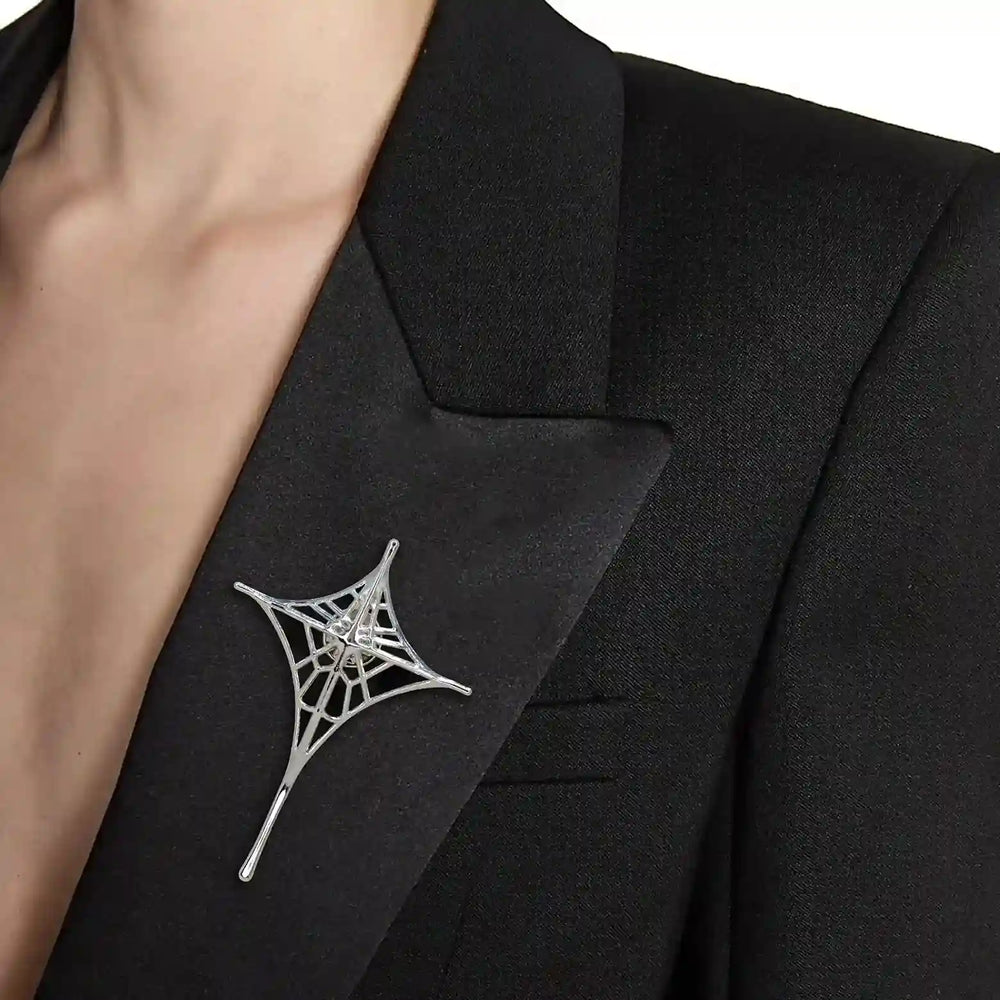 ANI Accessories spider web lapel pin worn on the lapel of a black blazer 
