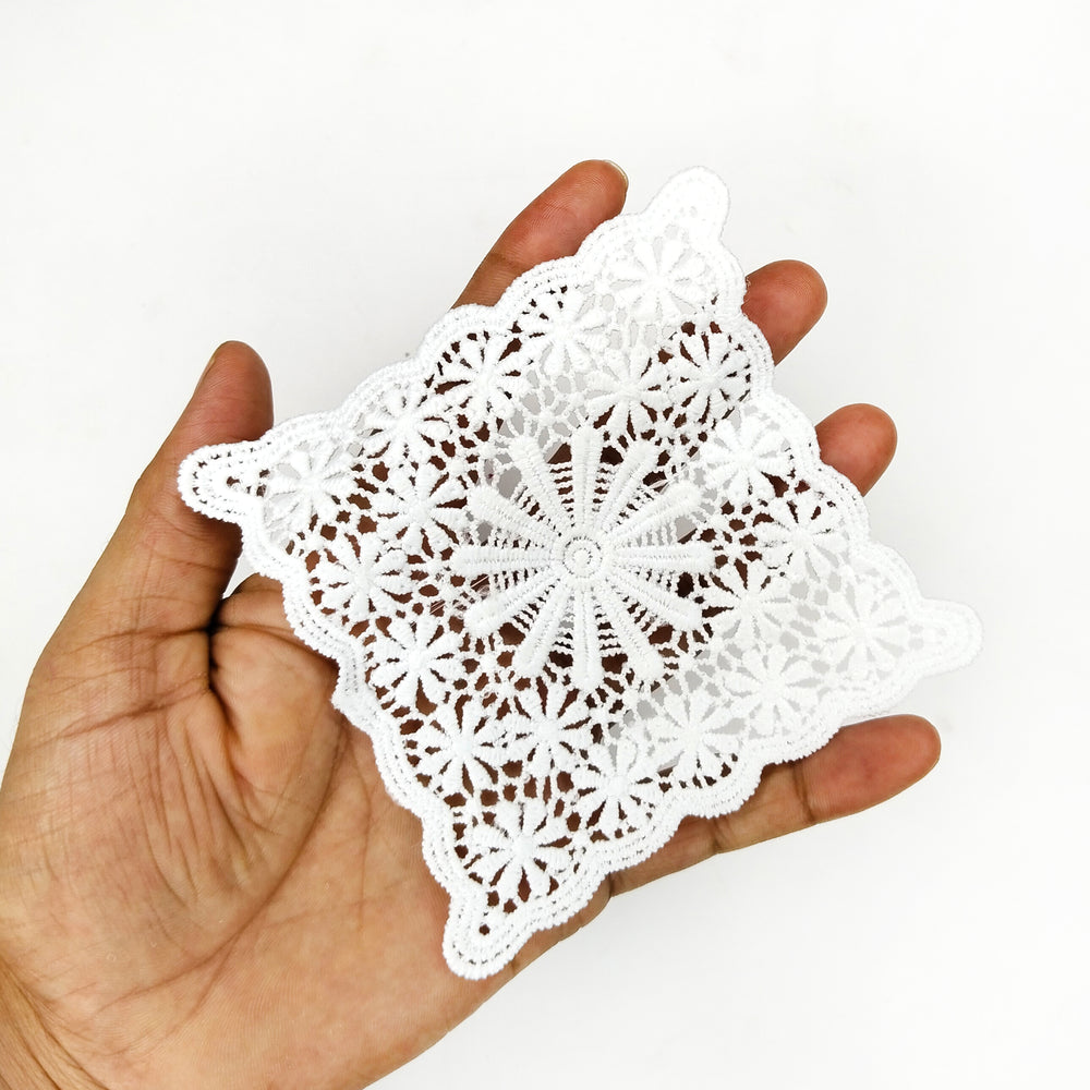 ANI Accessories square lace patch held in an open palm to show its 4 inch size 