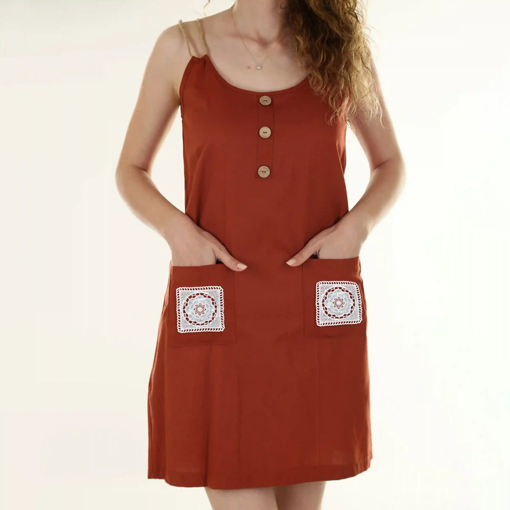 ANI Accessories white square patches stitched on the two front pockets of a rust dress 