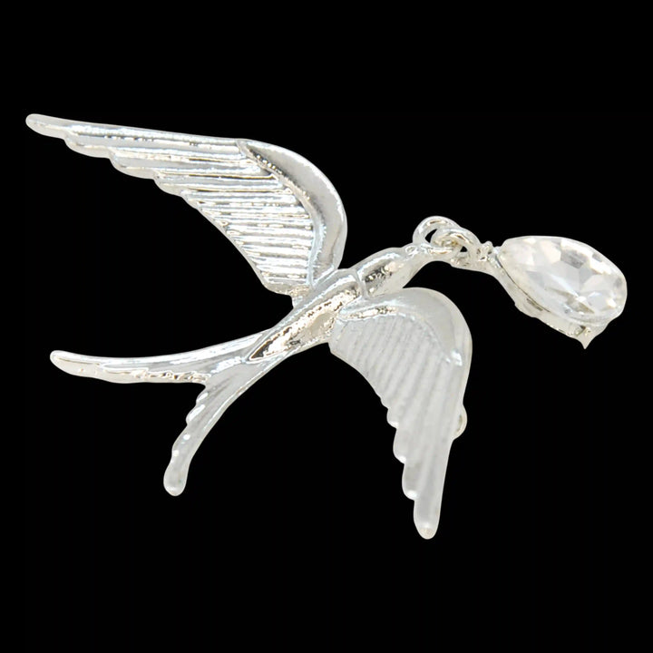Silver swallow bird brooch with crystal drop on a black background 