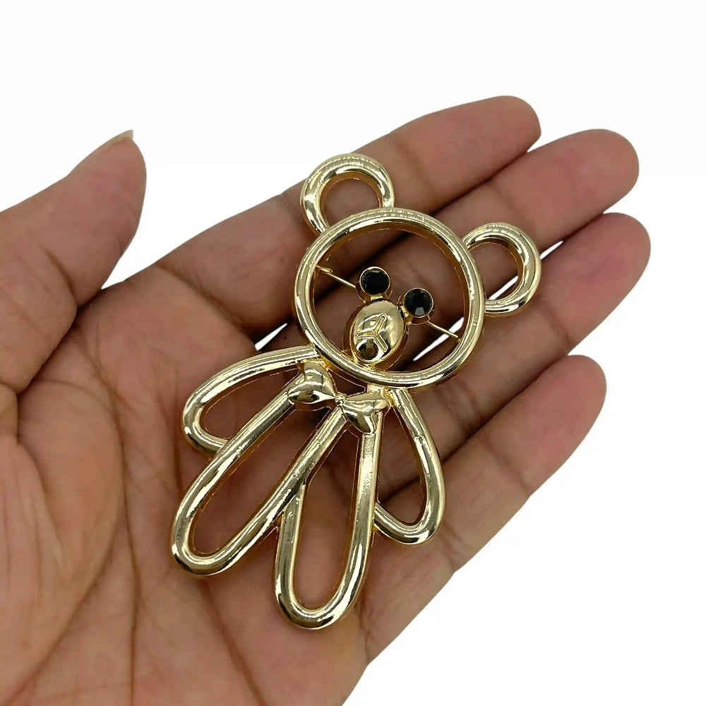 ANI Accessories teddy bear brooch pin held in hand to show its 7.5 cm size with white color background 