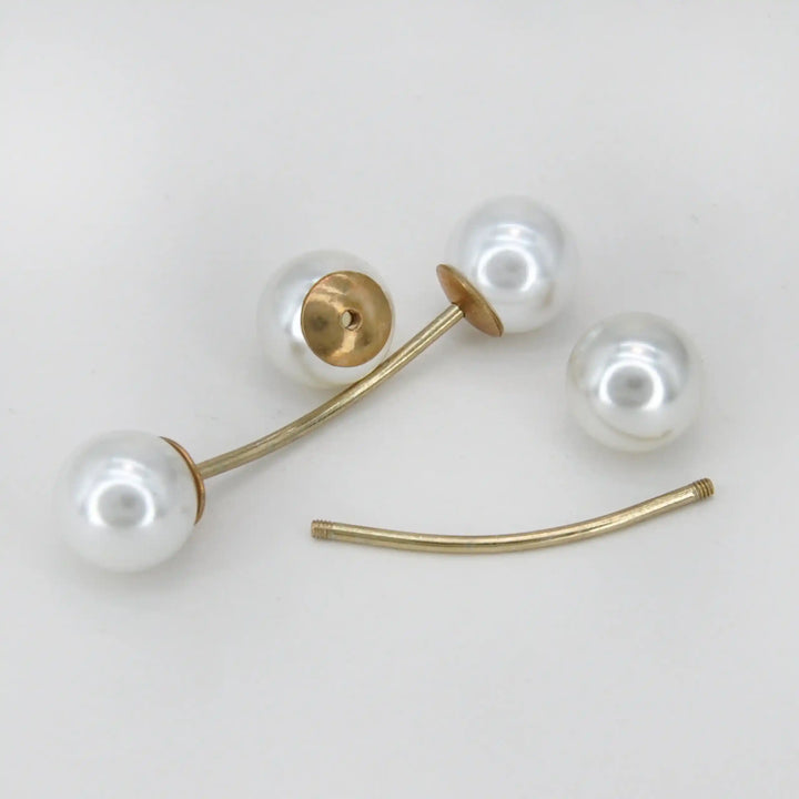 Twin pearl pin shown open with one pearl removed from the gold bar with white color background 