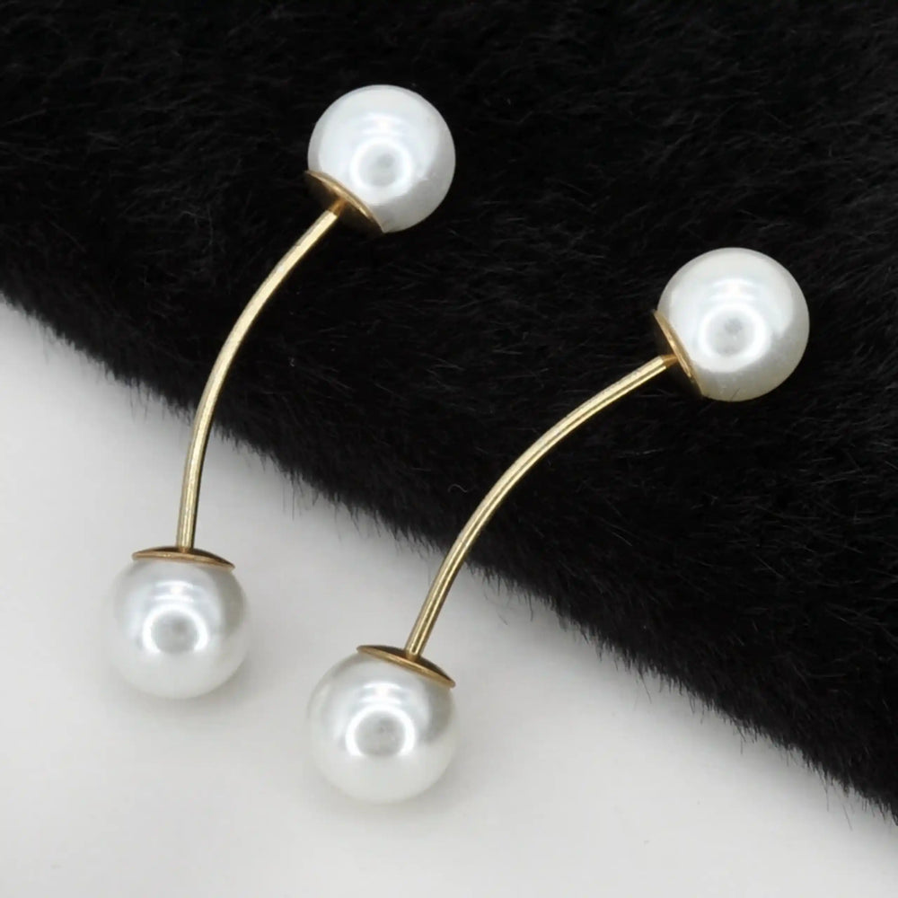 Twin pearl pins with gold bars on a black and white background with color and black fur background 