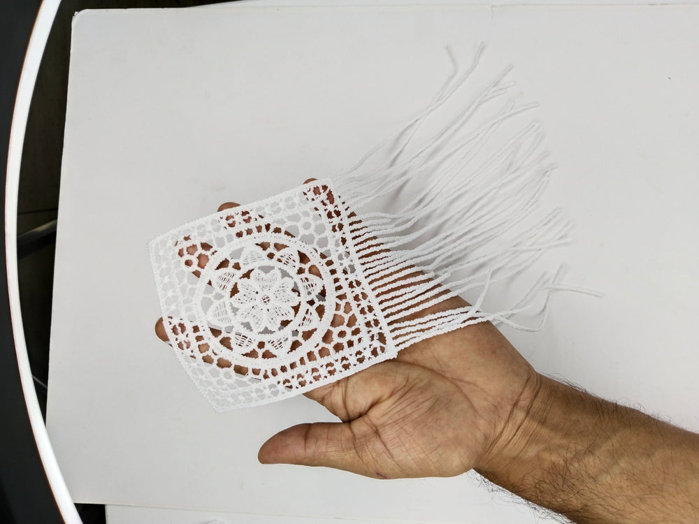 ANI Accessories white boho fringe patch resting on a hand to show the panel and fringe length 