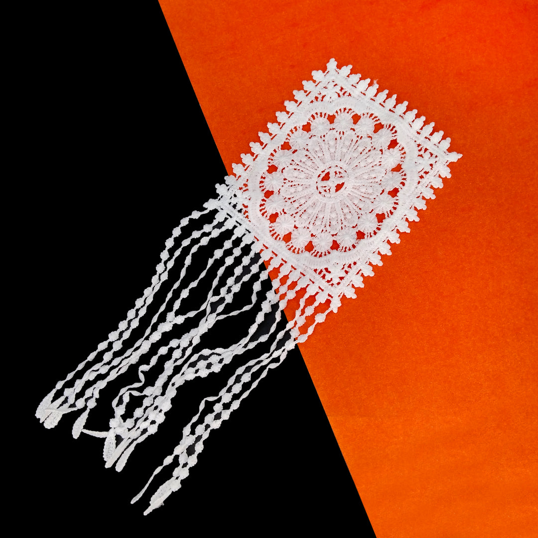 ANI Accessories white fancy patch with beaded-look strands on a black and orange background 