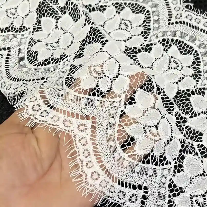 ANI Accessories white floral eyelash lace held in hand to show the sheer net