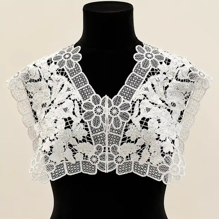 ANI Accessories white floral lace V-neck collar yoke on a black dress form, front view on beige background