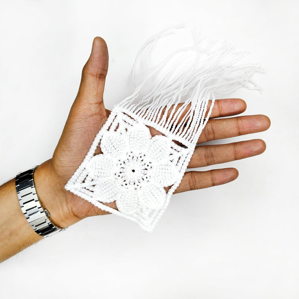 ANI Accessories white flower applique patch with fringe resting on a hand to show its size